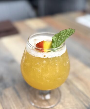 An orange cocktail in a glass