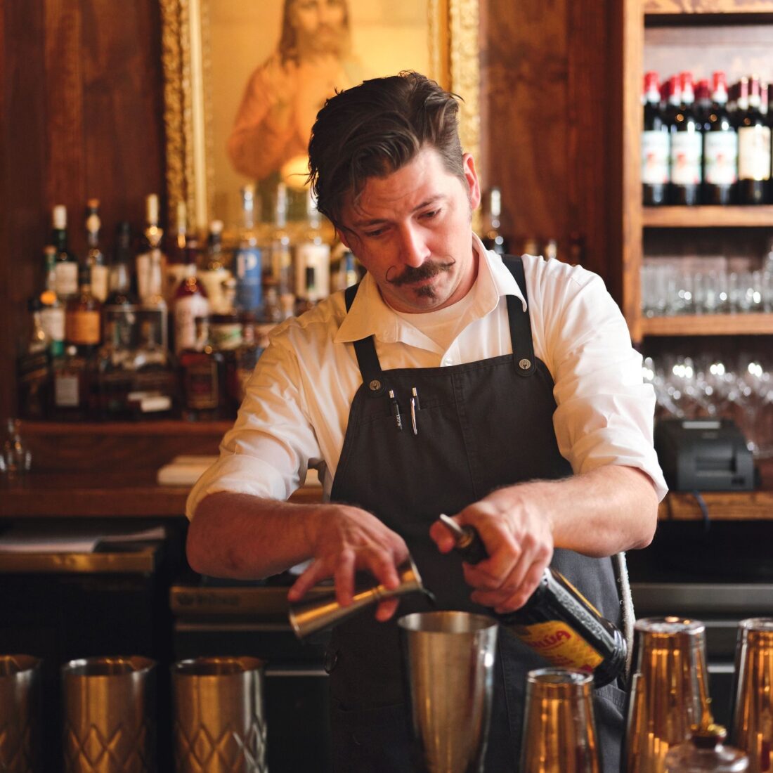 A bartender mixes drinks