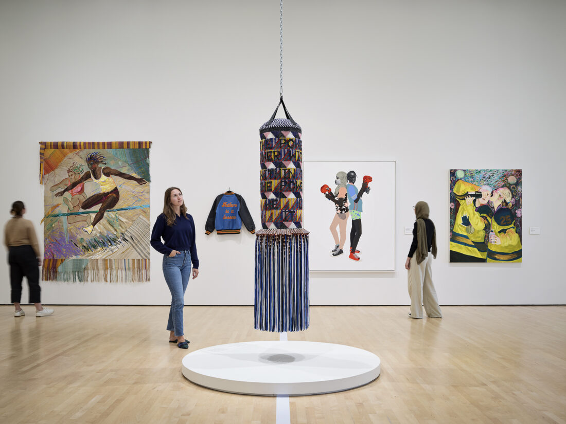 a woman looking at an installation