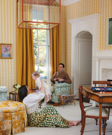 A family sits in a yellow room