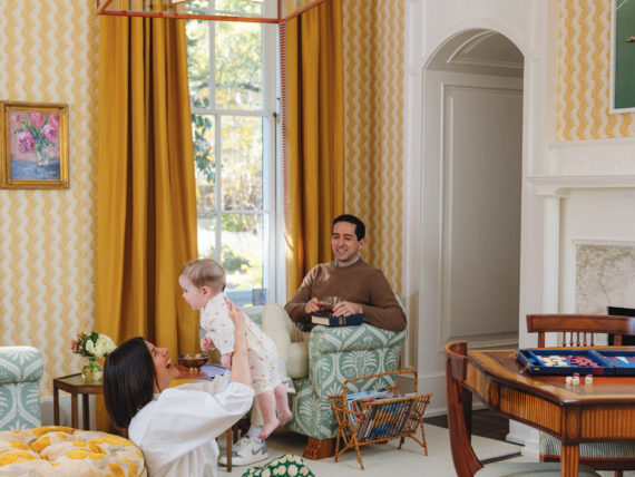 A family sits in a yellow room