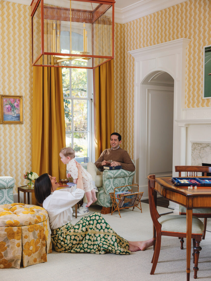A family sits in a yellow room