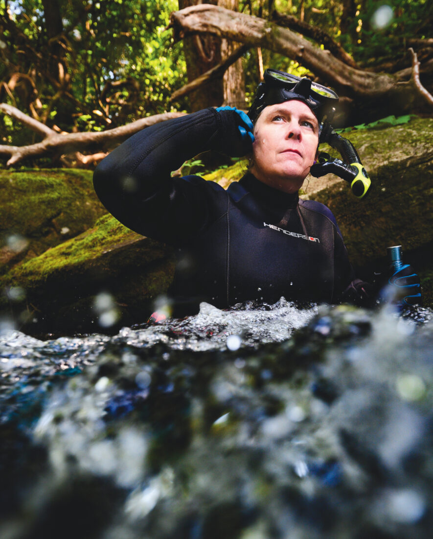 A woman snorkels in a river