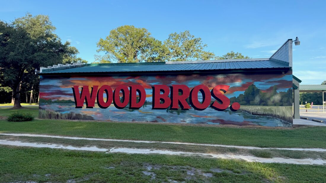 A painted side of a wood building that says "Wood Bros"