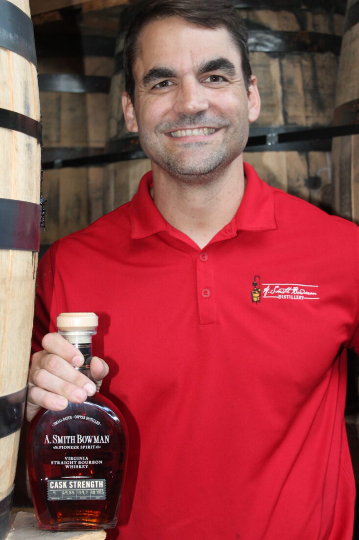 A portrait of a man holding bourbon