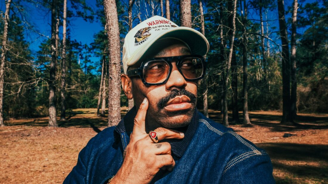 A man outside in a pine forest