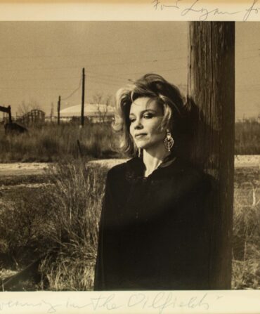 A portrait of a woman standing outside