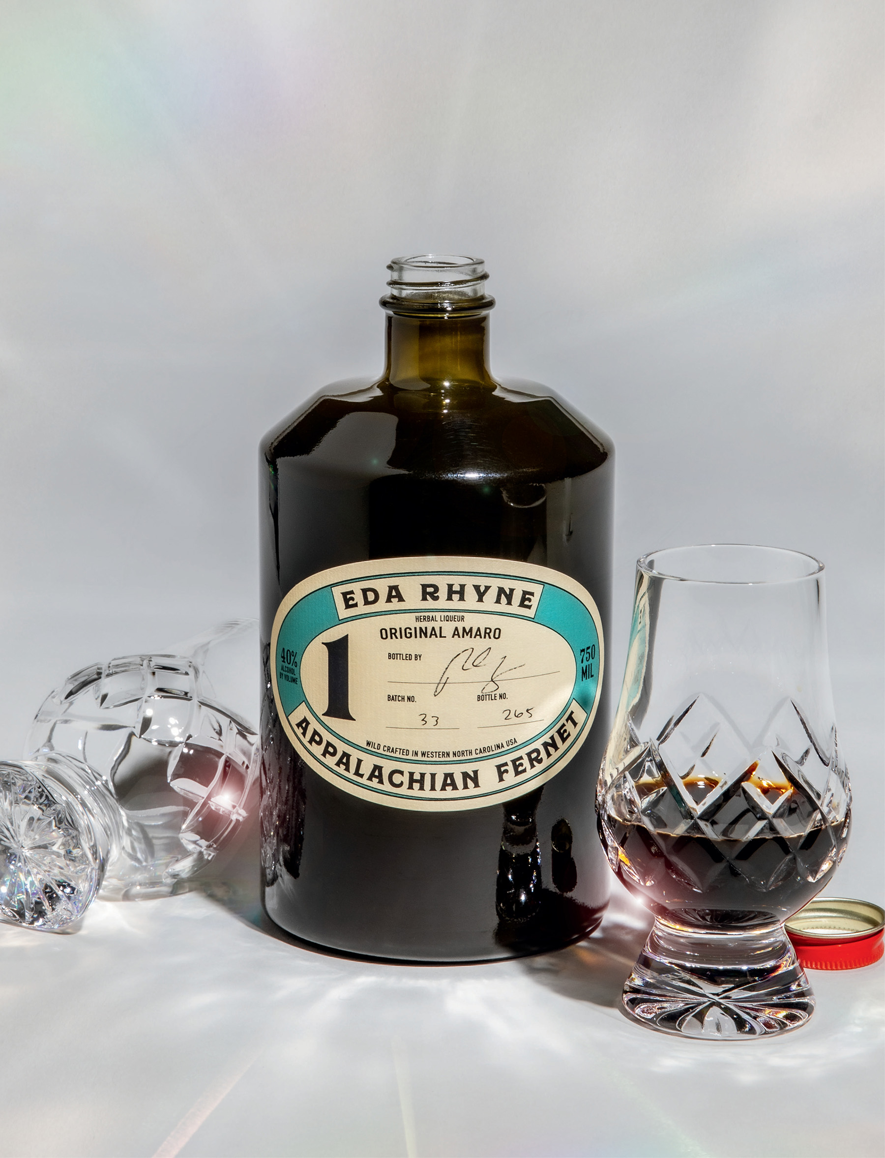 A bottle of liqueur and two glasses