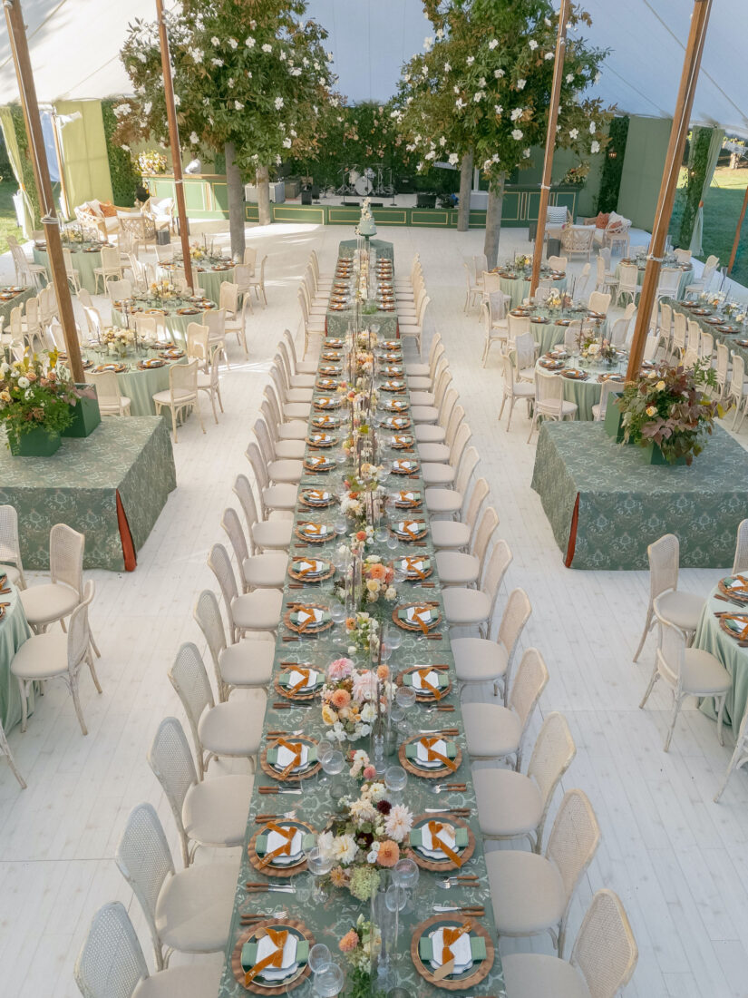 A set long table under a wedding tent
