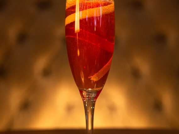 A cocktail in a tall flute glass