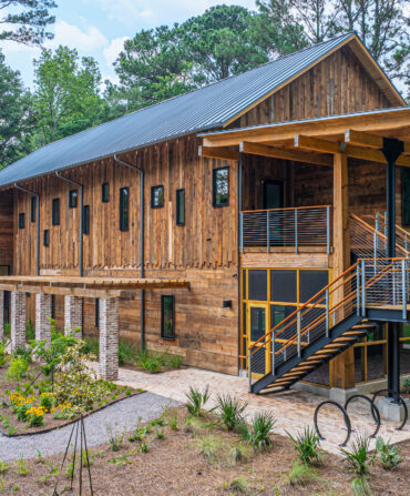 A wood building on a well-landscaped lot